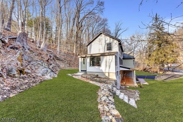 rear view of house featuring a yard