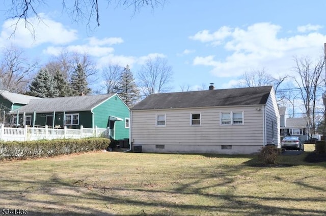 rear view of property featuring a yard