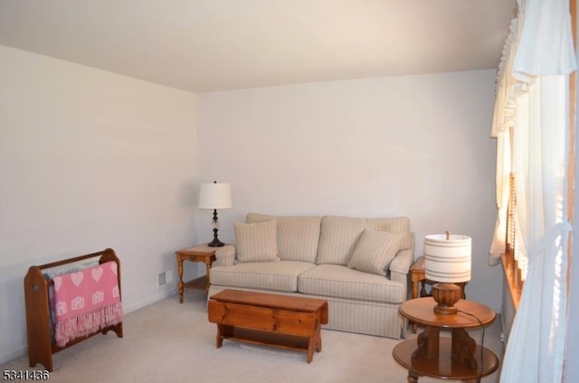 carpeted living room with baseboards