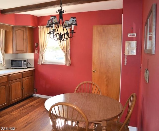 dining room with dark wood-style floors, baseboards, beam ceiling, and a notable chandelier