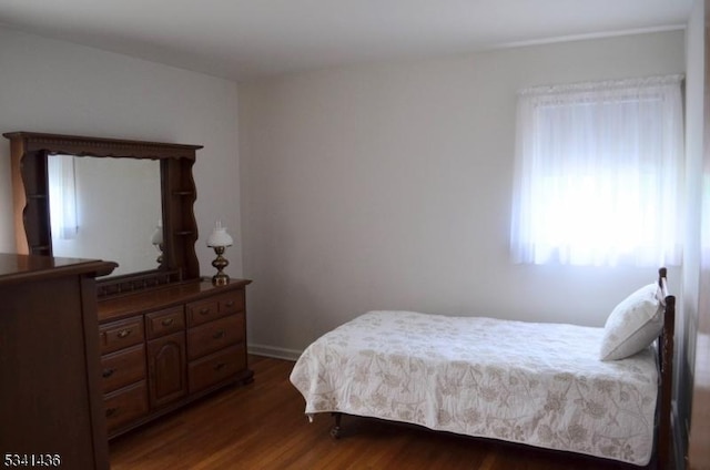 bedroom featuring dark wood-style flooring