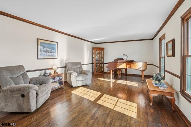 living room featuring ornamental molding, baseboards, and wood finished floors