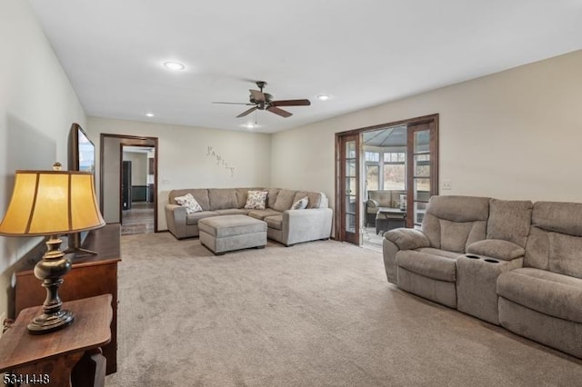 living area featuring carpet, ceiling fan, and recessed lighting