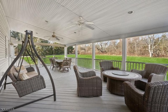 wooden terrace with ceiling fan and outdoor dining area