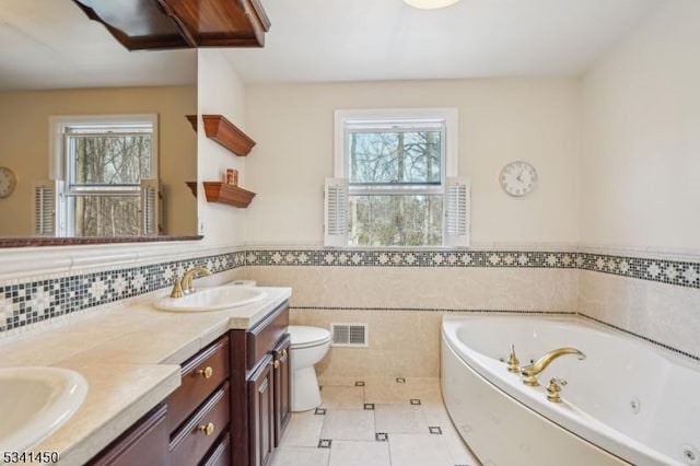 bathroom featuring a sink, visible vents, a wealth of natural light, and tile patterned floors