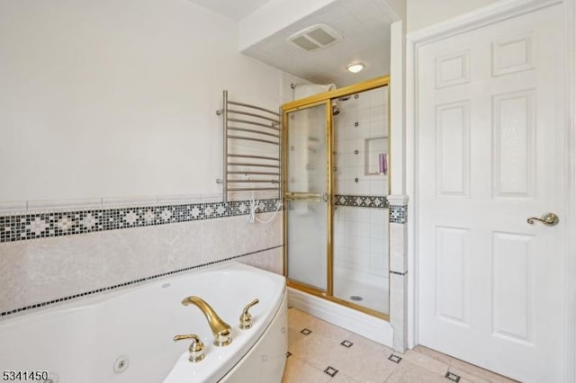 bathroom with a shower stall, a jetted tub, radiator, and visible vents