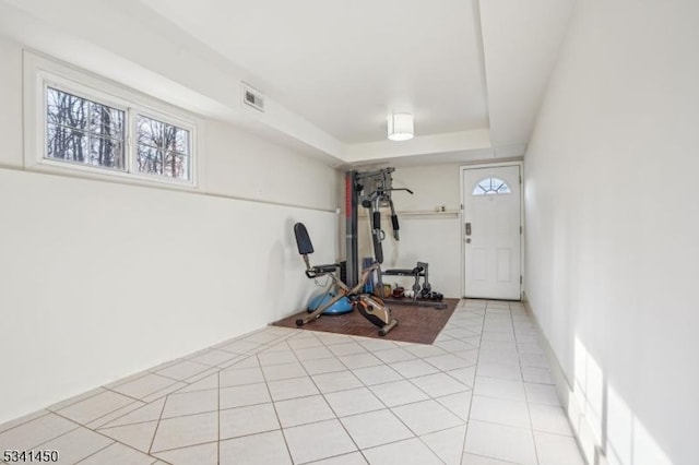 workout room with light tile patterned flooring and visible vents