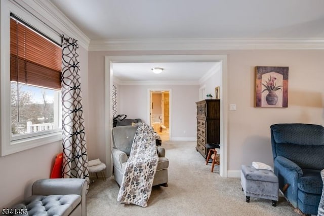 sitting room featuring ornamental molding, light carpet, and baseboards