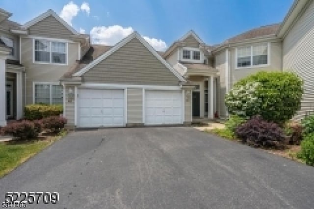 traditional-style house featuring aphalt driveway and a garage