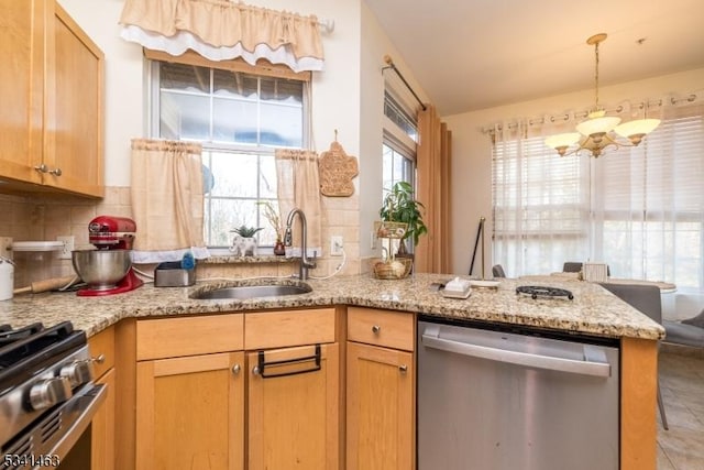 kitchen with a chandelier, light stone counters, decorative backsplash, stainless steel appliances, and a sink