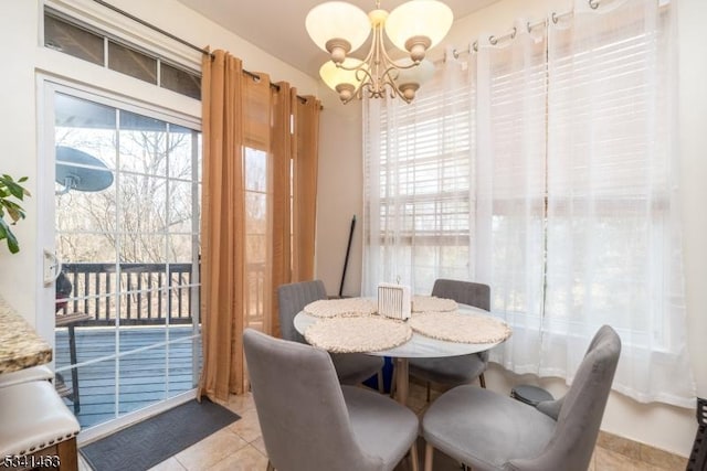 dining space with light tile patterned floors and a notable chandelier