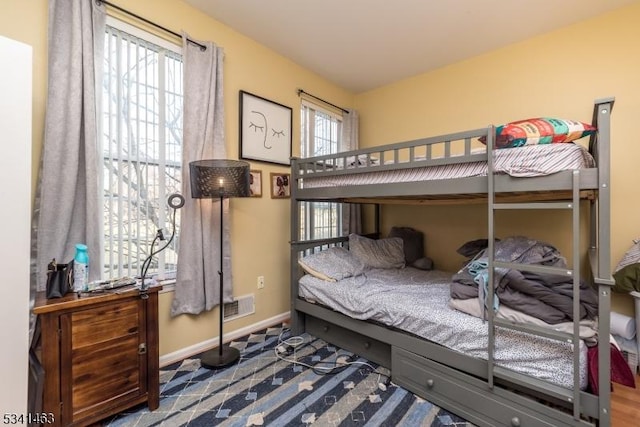 bedroom featuring visible vents and baseboards