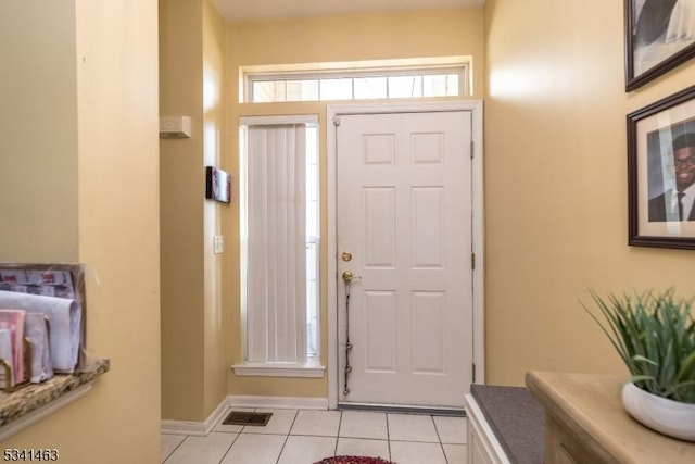 entrance foyer featuring light tile patterned floors, visible vents, and baseboards