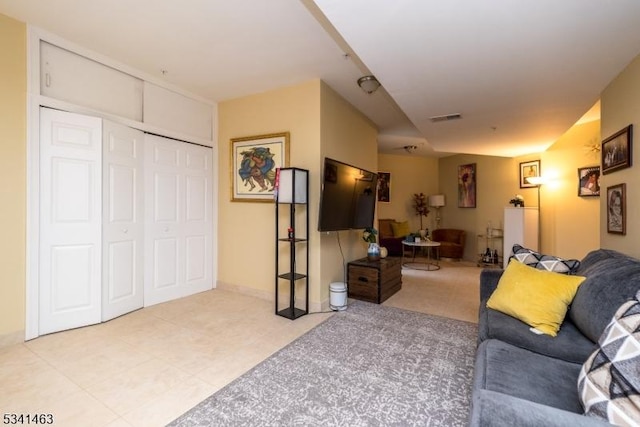 tiled living room featuring visible vents