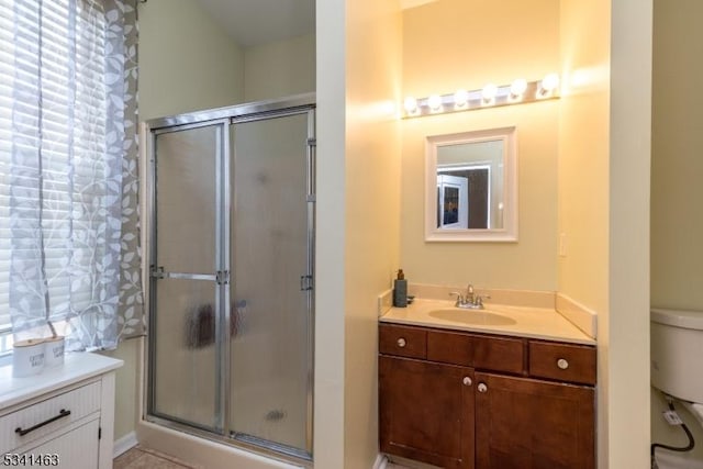 full bath featuring vanity, a shower stall, and toilet