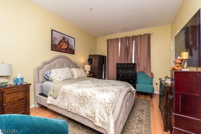 bedroom with light wood-style floors and baseboards