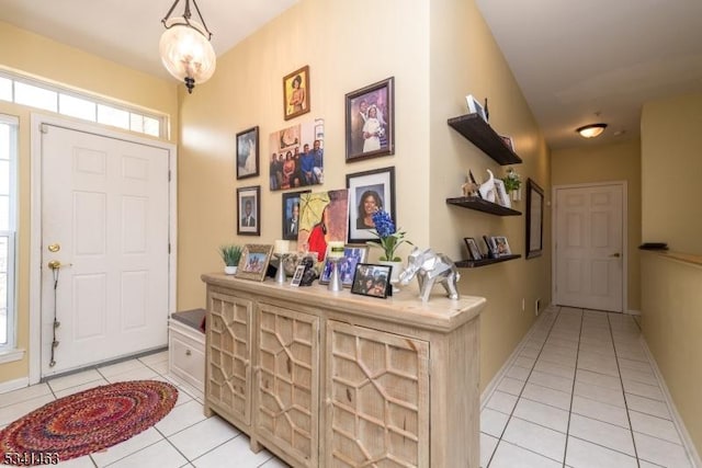 entrance foyer with light tile patterned flooring and baseboards