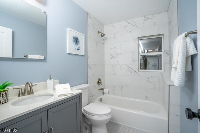 bathroom featuring toilet, bathtub / shower combination, and vanity