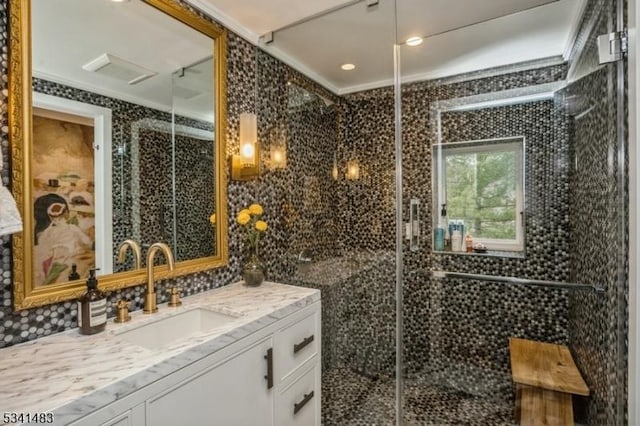 full bath featuring visible vents, vanity, and an enclosed shower