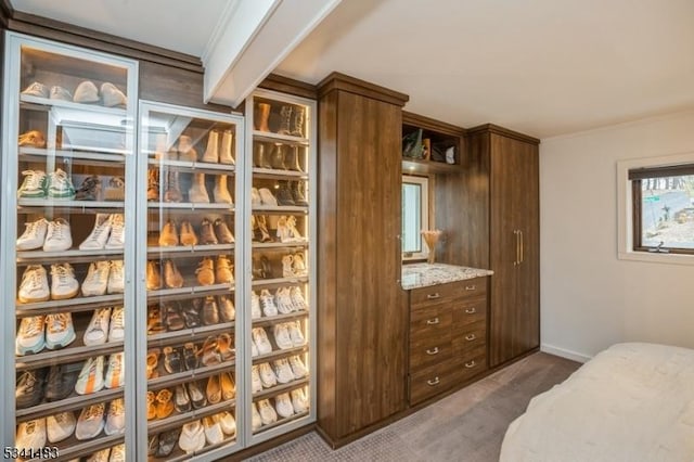 interior space featuring baseboards, dark carpet, and ornamental molding