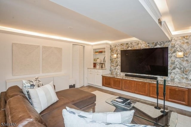 living room featuring light wood-type flooring and ornamental molding