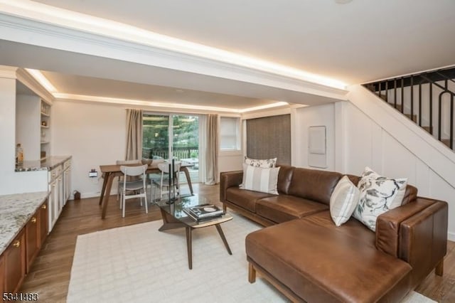 living area with stairway and light wood-type flooring