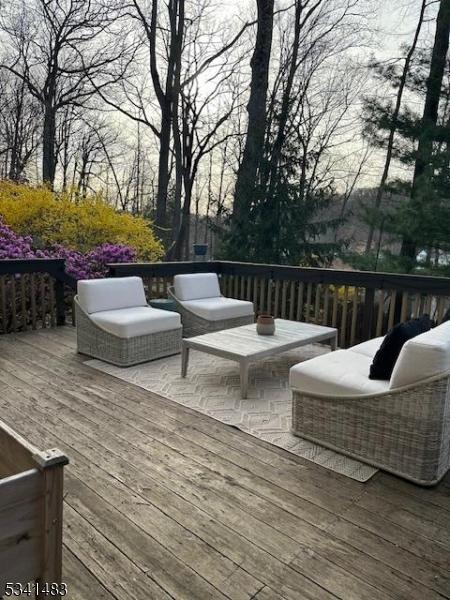 wooden deck with an outdoor living space