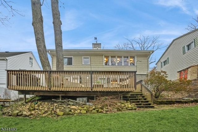 back of property with stairs and a deck