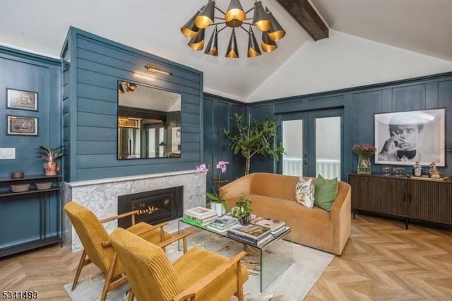 living room featuring a decorative wall, a notable chandelier, a high end fireplace, french doors, and beamed ceiling