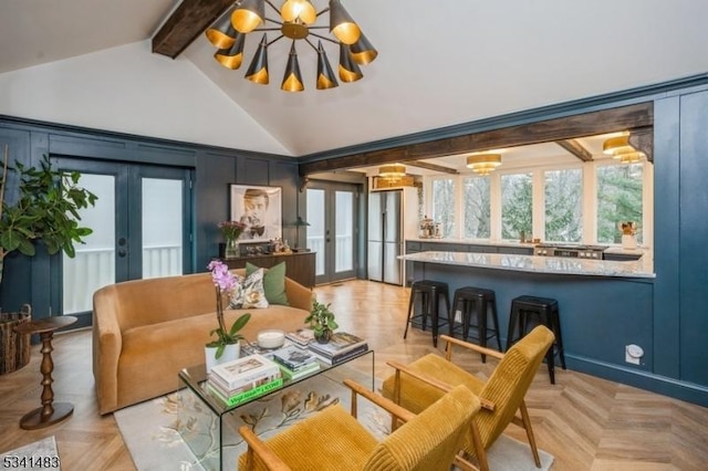 living area with a chandelier, a decorative wall, beam ceiling, and french doors