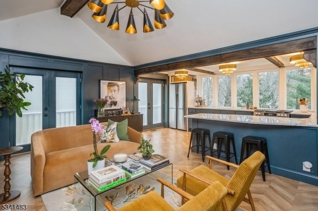 living room featuring high vaulted ceiling, french doors, beam ceiling, and an inviting chandelier