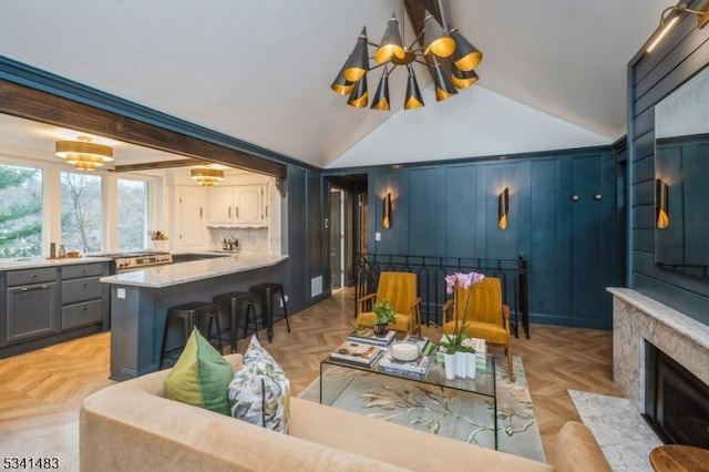 living room with vaulted ceiling and a fireplace