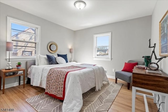 bedroom with light wood-style flooring and baseboards