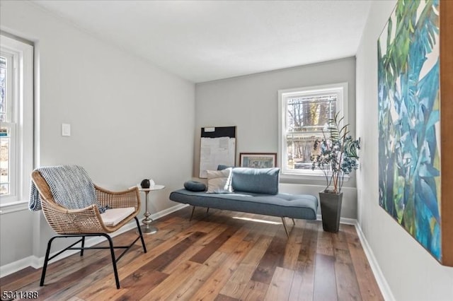 sitting room featuring hardwood / wood-style flooring and baseboards