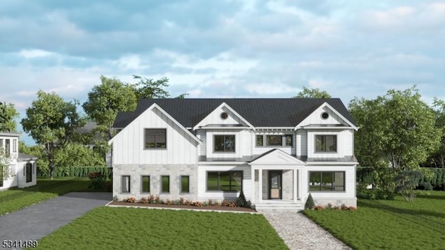 modern farmhouse style home featuring a front lawn and board and batten siding