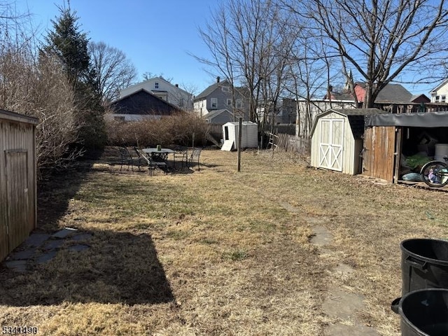 view of yard with a storage shed and an outdoor structure