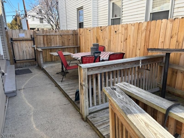 wooden terrace featuring fence