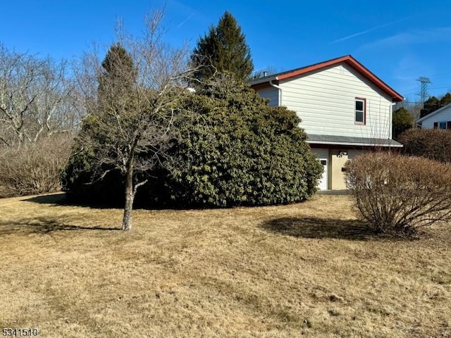 view of side of home with a lawn