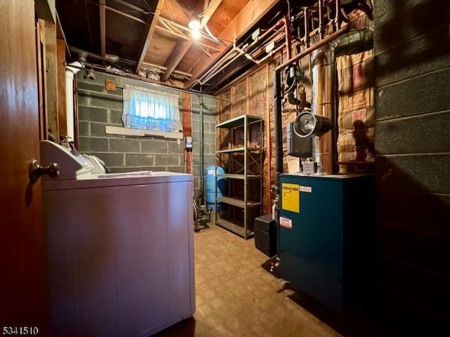 interior space with a heating unit, washer / clothes dryer, and tile patterned floors