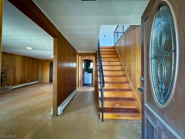 interior space featuring baseboard heating, tile patterned floors, and wooden walls