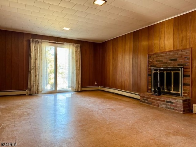 unfurnished living room with a brick fireplace, wooden walls, a baseboard heating unit, and tile patterned floors