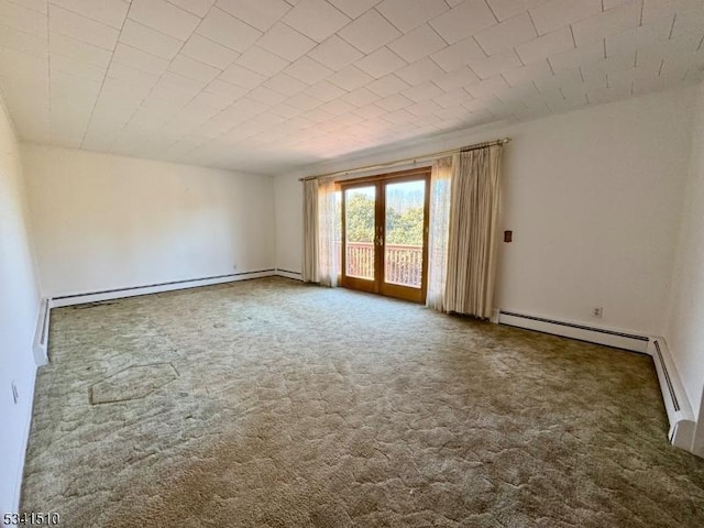 unfurnished room featuring a baseboard heating unit, carpet floors, and french doors