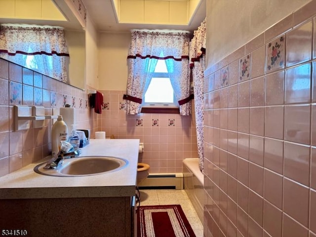 full bath featuring toilet, a baseboard heating unit, vanity, tile walls, and shower / bath combination with curtain