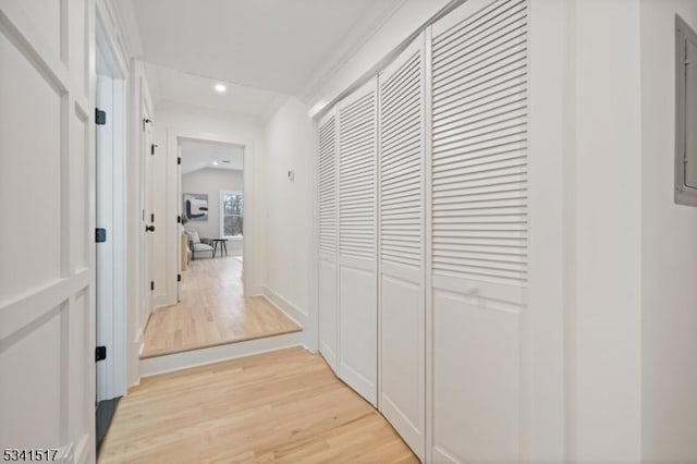 corridor with recessed lighting, crown molding, and light wood finished floors