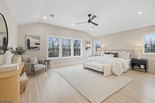 bedroom with lofted ceiling, light wood-style floors, and visible vents