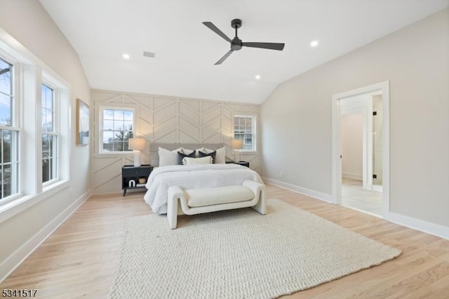 bedroom featuring baseboards, lofted ceiling, and light wood-style floors