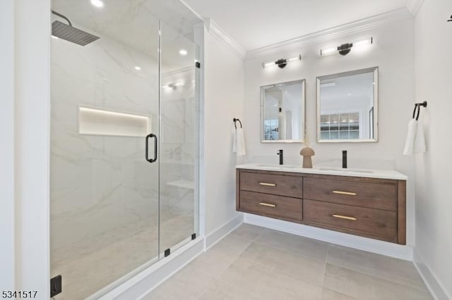 full bath featuring baseboards, a marble finish shower, double vanity, a sink, and ornamental molding