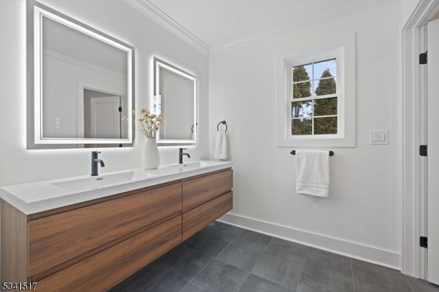 bathroom featuring crown molding, double vanity, baseboards, and a sink