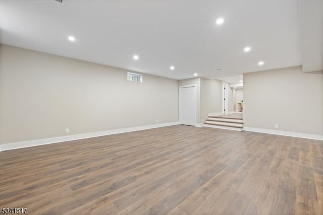 finished below grade area with visible vents, recessed lighting, wood finished floors, and baseboards