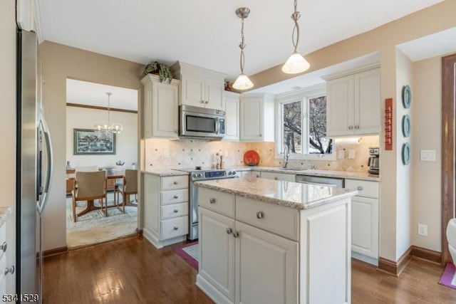 kitchen with stainless steel appliances, dark wood-style flooring, and decorative backsplash